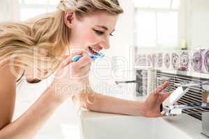 Young woman brushing teeth