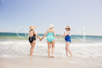 Senior woman friends playing in water