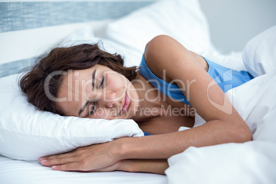 Young woman sleeping on bed