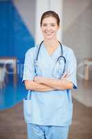 Portrait of beautiful happy female doctor with arms crossed