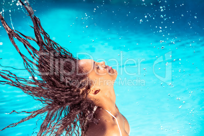 Beautiful woman tossing her wet hair
