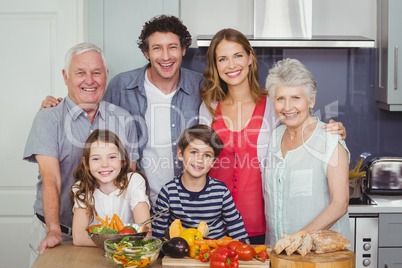 Portrait of happy family standing in kitchen