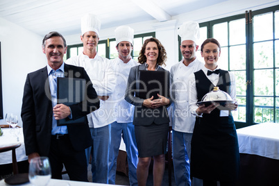 Happy restaurant team standing together in restaurant
