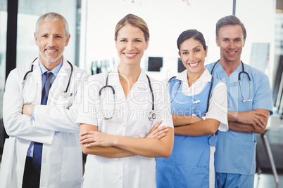 Happy medical team standing with arms crossed