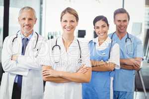 Happy medical team standing with arms crossed