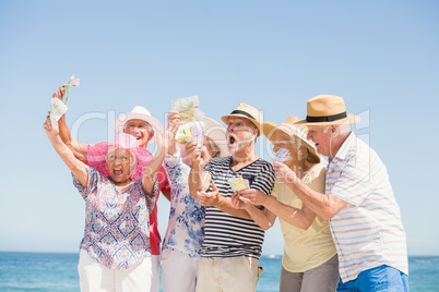 Senior friends holding money