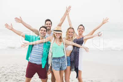 Group of happy friends standing on the beach