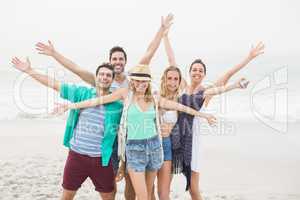 Group of happy friends standing on the beach