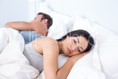 Upset couple lying on bed