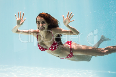 Cheerful young woman swimming