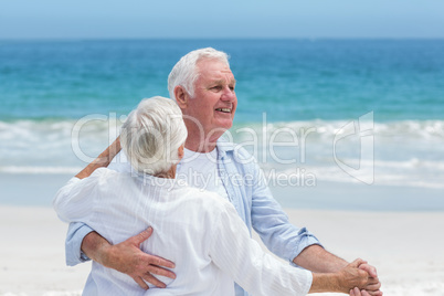 Senior couple dancing at the beach