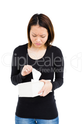 Woman taking a tissue from tissue box