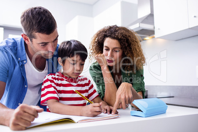 Parents helping son with homework