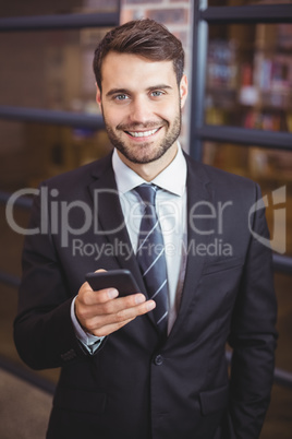 Businessman using cellphone in office