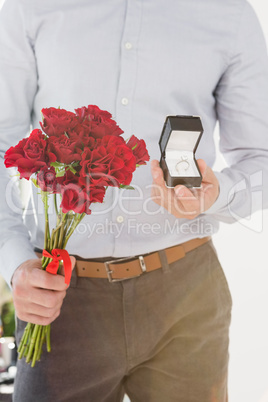 Happy young man holding engagement ring