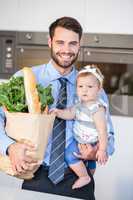 Cheerful businessman carrying vegetables and daughter