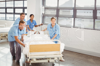 Group of doctors carrying woman patient