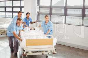 Group of doctors carrying woman patient