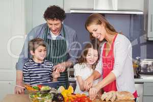 Happy parents with son and daughter in kitchen