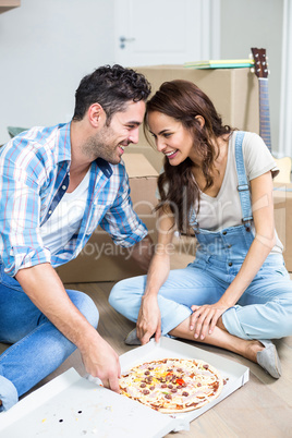 Smiling couple having pizza