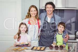 Portrait of happy family standing in kitchen