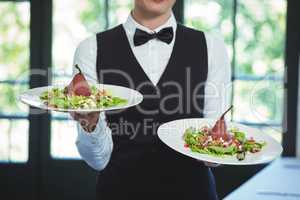 Waitress holding plates