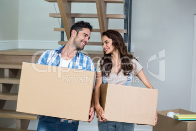 Cheerful couple with cardboard boxes