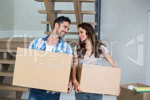 Cheerful couple with cardboard boxes
