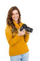 Happy young woman using camera