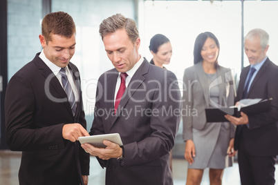Businessmen using digital tablet