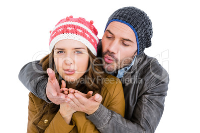 Happy young couple blowing kiss