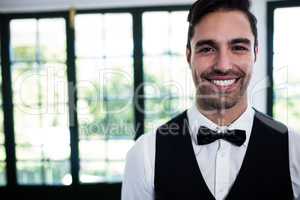 Portrait of waiter smiling at camera