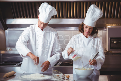 Focused chef preparing a cake