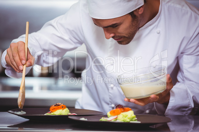 Chef putting sauce on a dish