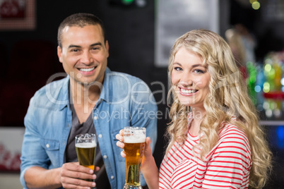 Smiling couple drinking beer