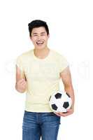 Man holding football and smiling