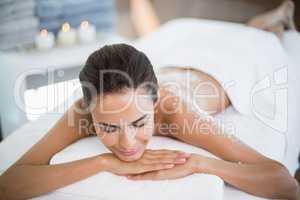 Beautiful woman relaxing on massage table at spa