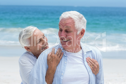 Senior couple embracing with arms around