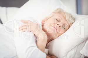 Senior woman sleeping on bed