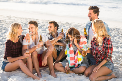 Friends drinking beer at the beach