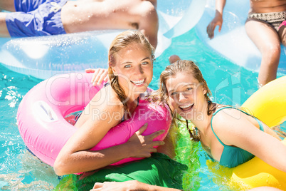 Happy friends enjoying in the swimming pool