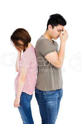 Depressed couple standing back to back