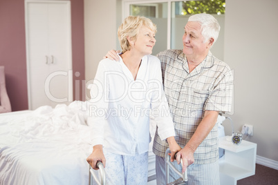 Senior smiling couple with walker