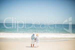 Senior couple holding hands on the beach