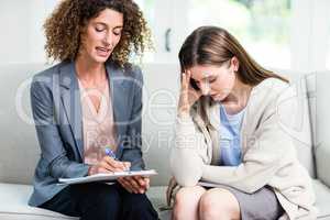 Psychologist counselling upset woman at home