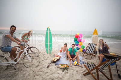 Group of friends having picnic on the beach