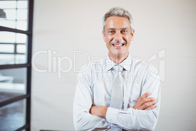 Portrait of smiling business professional with arms crossed