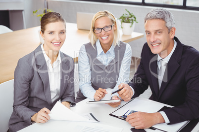 Business people smiling while sitting with client