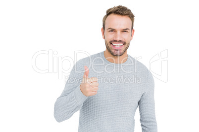 Young man smiling and giving a thumbs up