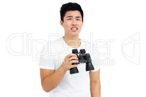 Young man holding binoculars